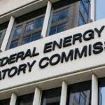Exterior view of the federal energy regulatory commission building, showcasing its sign on the facade.
