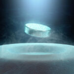 A 3d illustration of a levitating sparkling blue tablet above a frosty white cylindrical base with smoke around.