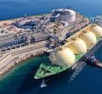 LNG tanker docked at coastal industrial facility.